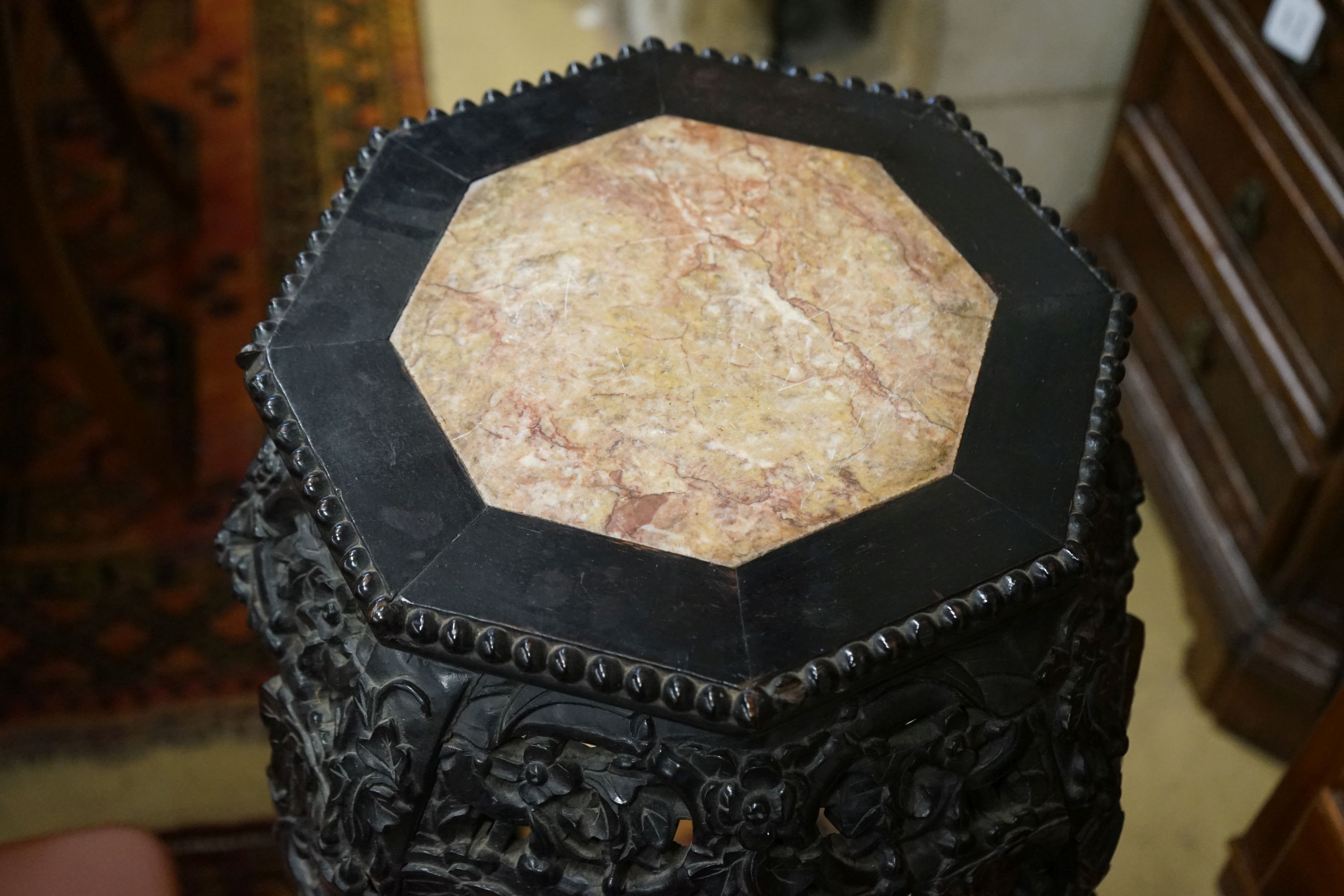 A Chinese carved hardwood marble top octagonal vase stand, width 40cm, height 90cm